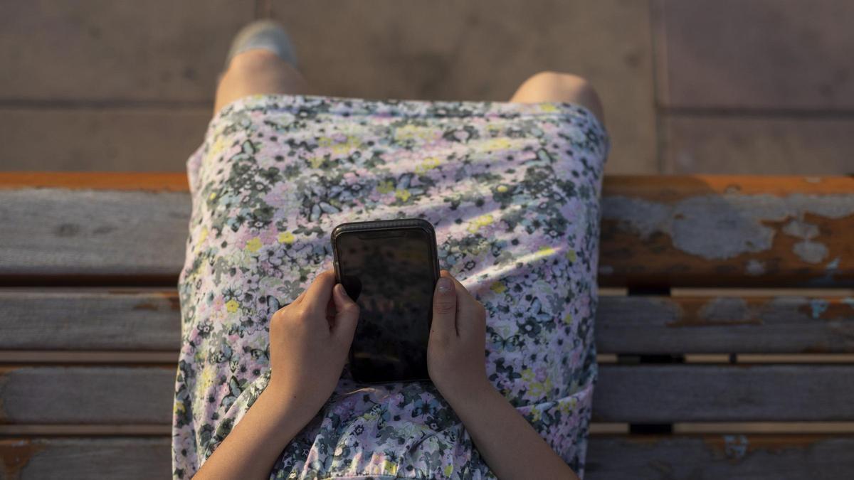 Una joven mira su teléfono, en una imagen de archivo.