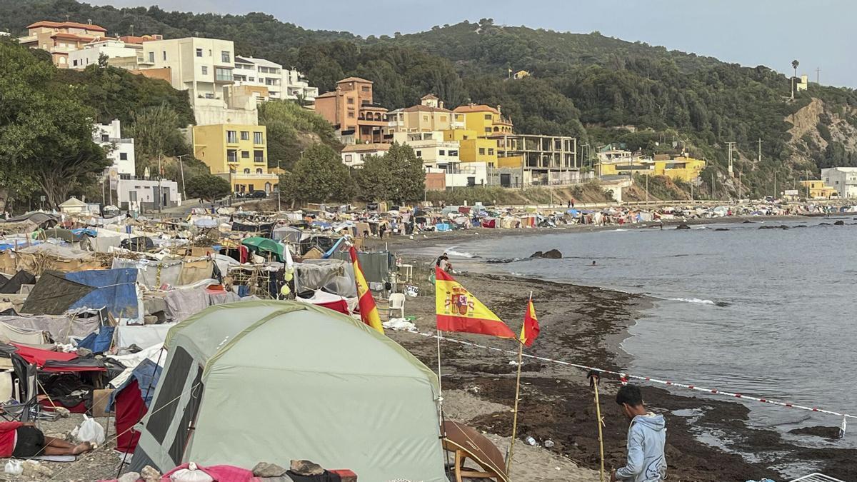 Vista de las tiendas de campaña y construcciones improvisadas por los migrantes asentados en la playa del Trampolín, este domingoen Ceuta. EFE/ Reduan